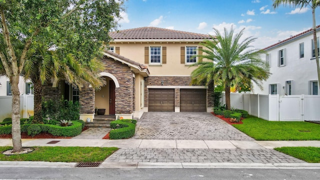 mediterranean / spanish-style house with a garage