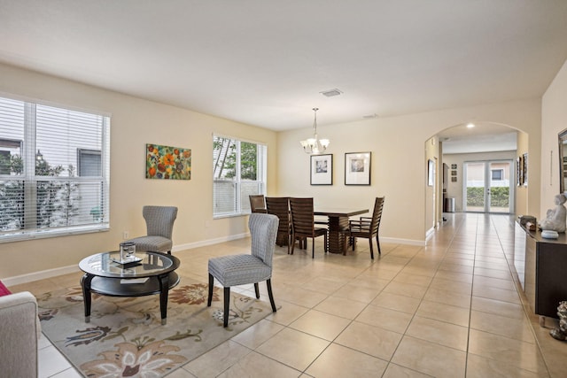 tiled dining room with an inviting chandelier