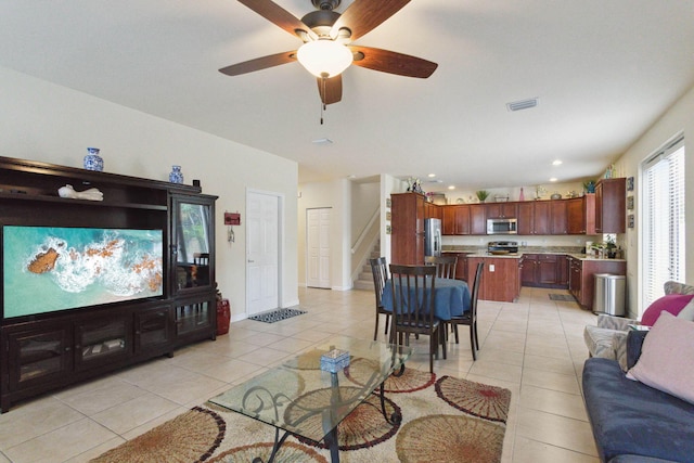 tiled living room with ceiling fan