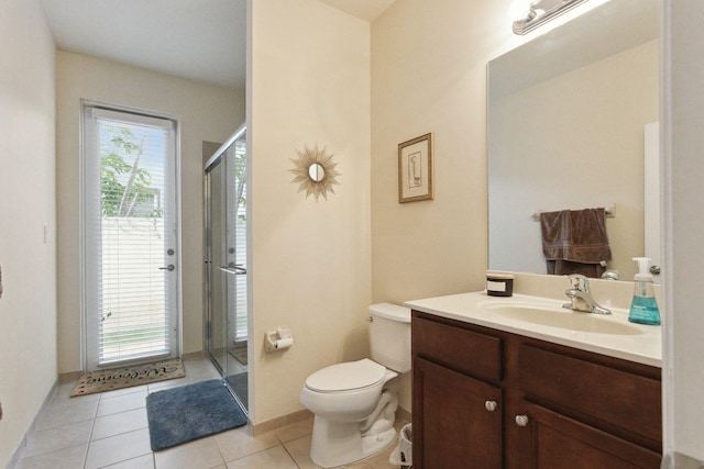 bathroom with vanity, toilet, a shower with shower door, and tile patterned flooring