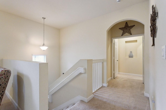 hallway with light colored carpet