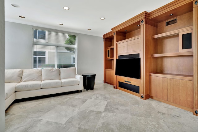 unfurnished living room with built in shelves and crown molding