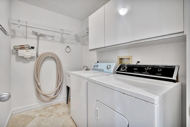 laundry room featuring cabinets and separate washer and dryer