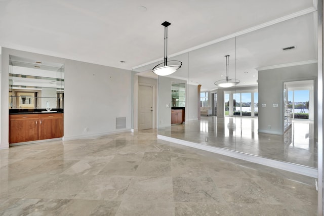 unfurnished living room featuring crown molding