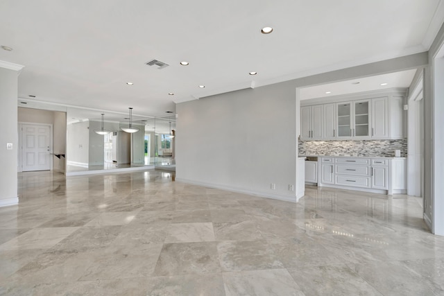 unfurnished living room with ornamental molding