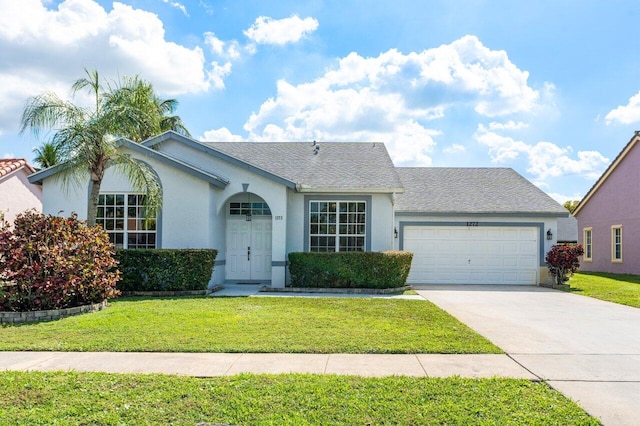 single story home featuring a garage and a front yard