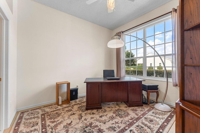 office space featuring vaulted ceiling, a textured ceiling, and ceiling fan