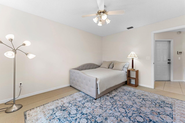 bedroom featuring ceiling fan, a textured ceiling, and carpet flooring