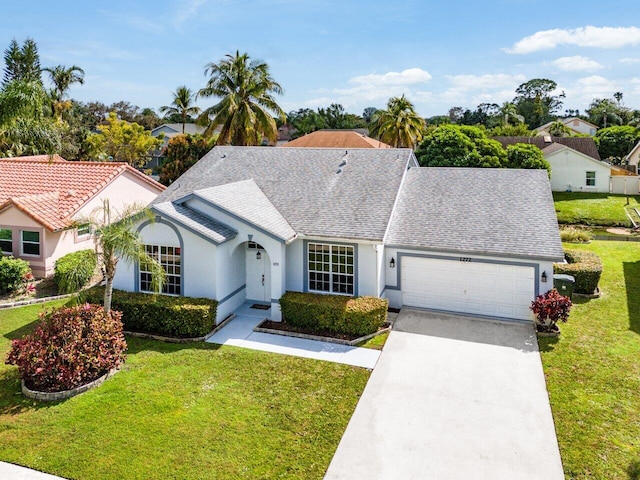 ranch-style home featuring a garage and a front yard