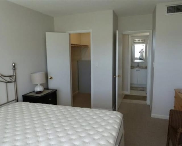 bedroom featuring a spacious closet and a closet