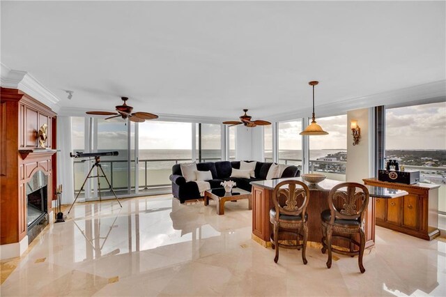 3554 Ocean Dr Unit Ph4S, Vero Beach, FL 32963 - living area with expansive windows, ornamental molding, a fireplace, ceiling fan, and marble finish floor