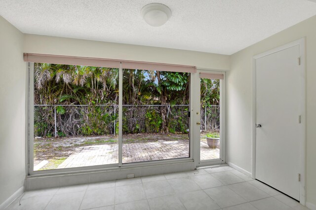 20835 Wendall Ter Unit 68, Boca Raton, FL 33433 - entryway featuring baseboards, a textured ceiling, and tile patterned flooring