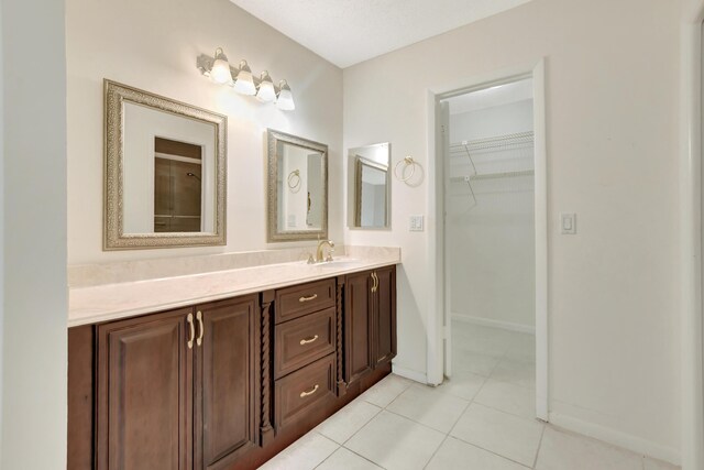 20835 Wendall Ter Unit 68, Boca Raton, FL 33433 - bathroom featuring vanity, a walk in closet, tile patterned flooring, and baseboards