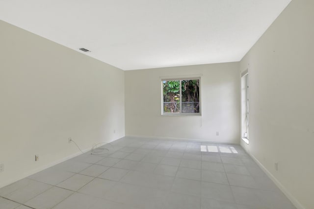 spare room featuring light tile patterned floors