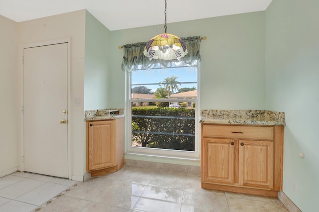 unfurnished dining area featuring light tile patterned floors