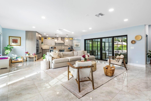 living area with marble finish floor, recessed lighting, visible vents, and baseboards