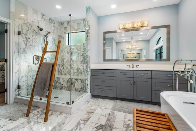 full bathroom with recessed lighting, vanity, a freestanding bath, marble finish floor, and a marble finish shower