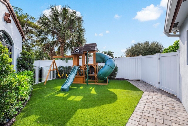 view of play area featuring a fenced backyard and a yard