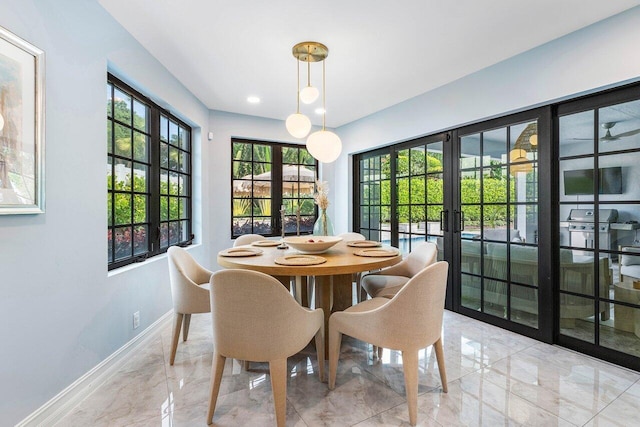 dining space featuring marble finish floor, baseboards, and french doors