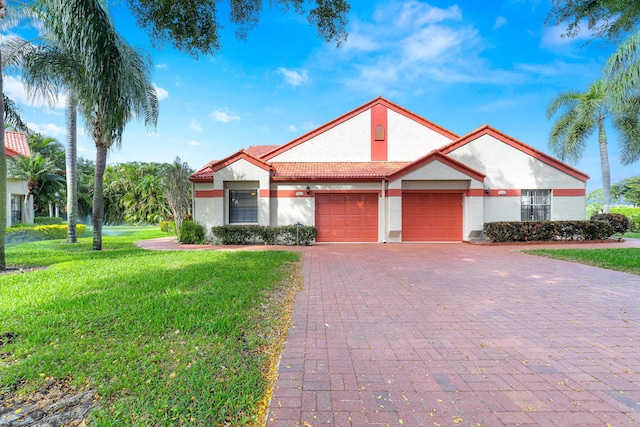 mediterranean / spanish-style home featuring a front lawn and a garage