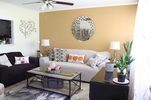 living room with hardwood / wood-style flooring, ceiling fan, and ornamental molding