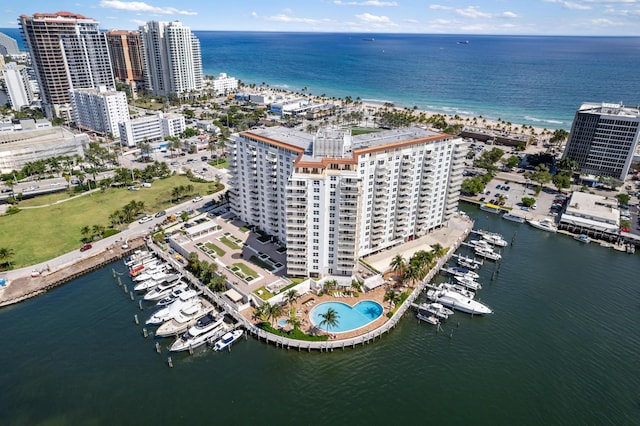 birds eye view of property featuring a water view and a city view