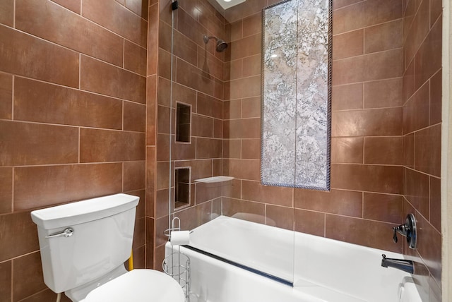 full bath with shower / tub combination, tile walls, and toilet