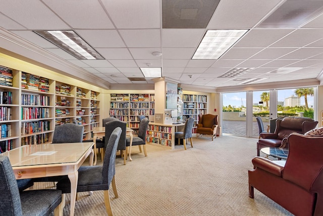 carpeted office space with bookshelves and crown molding