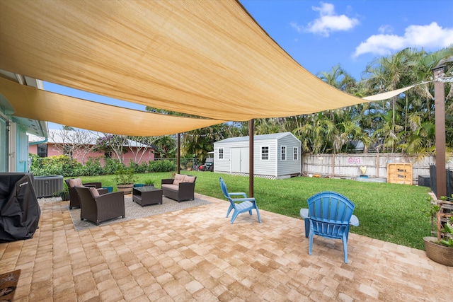 view of patio with an outdoor living space and a shed