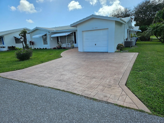 ranch-style home featuring central AC unit, a garage, and a front lawn