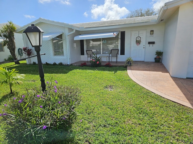 single story home with a porch and a front yard