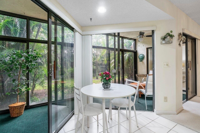 sunroom / solarium featuring ceiling fan