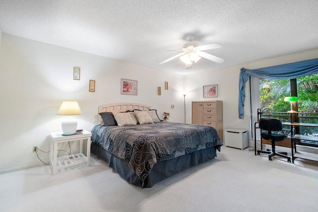 bedroom featuring ceiling fan, radiator heating unit, and a textured ceiling