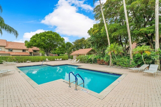 view of swimming pool with a patio