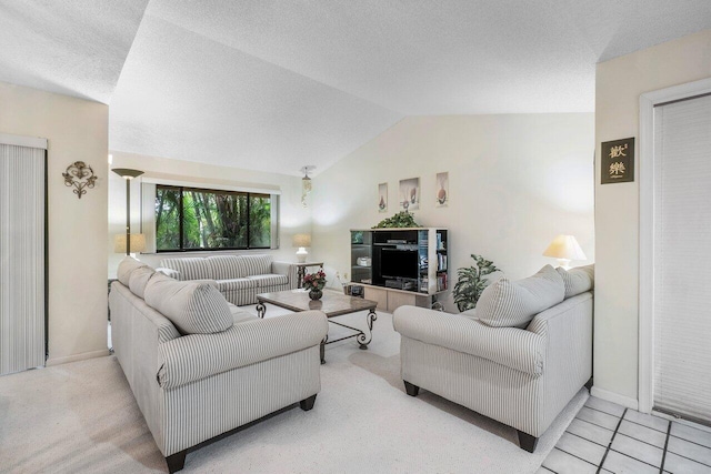 living room with lofted ceiling, a textured ceiling, and light tile patterned flooring