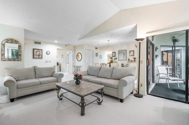 carpeted living room featuring vaulted ceiling and a textured ceiling