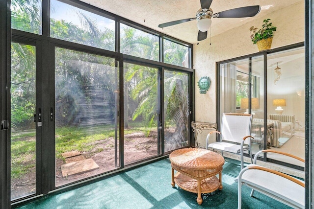 sunroom featuring ceiling fan