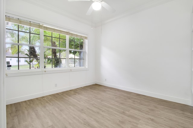 empty room with ceiling fan, crown molding, and light wood-type flooring