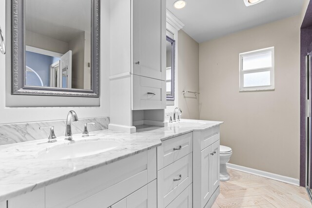 bathroom featuring toilet and vanity