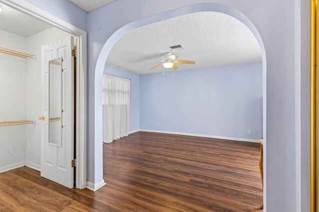 spare room featuring ceiling fan, dark wood-type flooring, french doors, and a textured ceiling