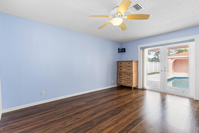 unfurnished room featuring dark hardwood / wood-style flooring, ceiling fan, and a textured ceiling