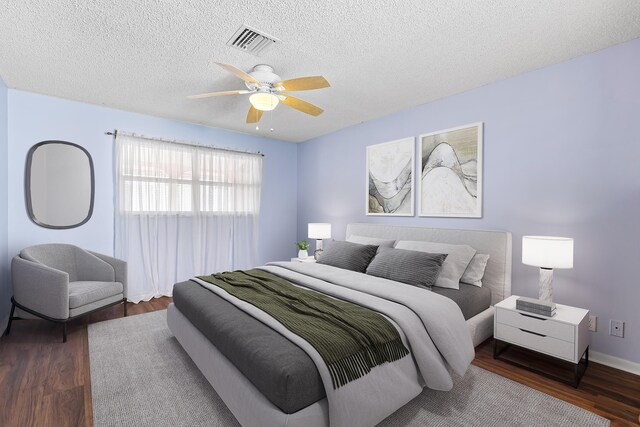 tiled empty room with ceiling fan and a textured ceiling