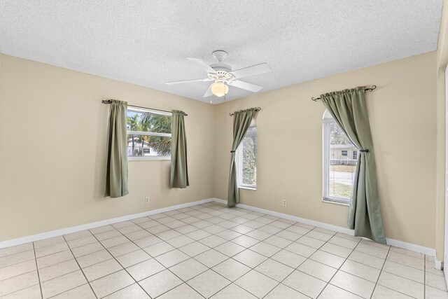 tiled bedroom featuring ceiling fan and a textured ceiling