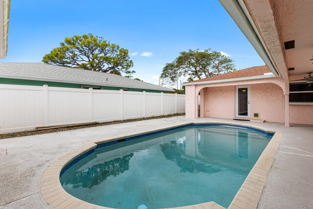 pool at dusk featuring french doors and a patio