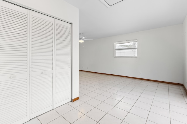 empty room featuring light tile patterned floors and ceiling fan