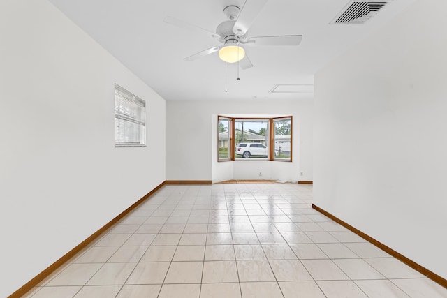 tiled empty room with ceiling fan