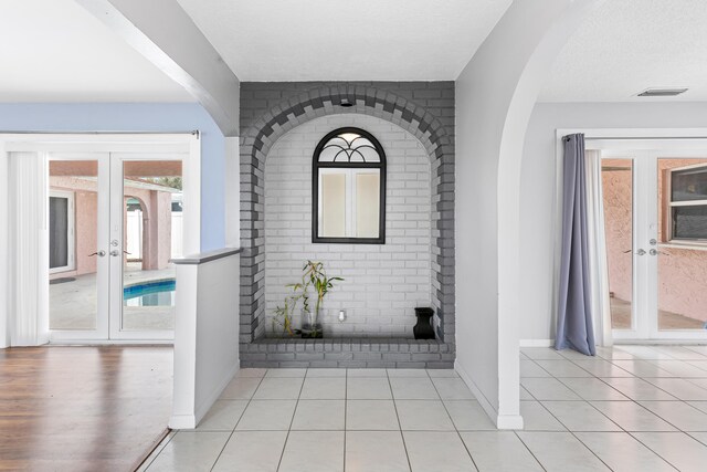 tiled entryway with a wealth of natural light