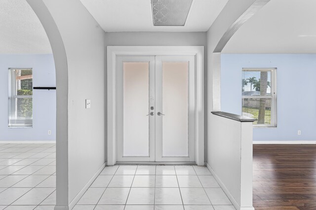 spare room featuring ceiling fan, french doors, and hardwood / wood-style floors