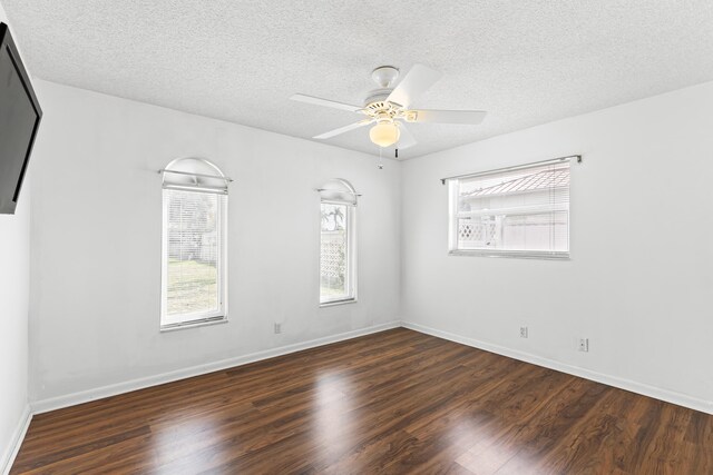 bedroom with ceiling fan, dark wood-type flooring, and a textured ceiling