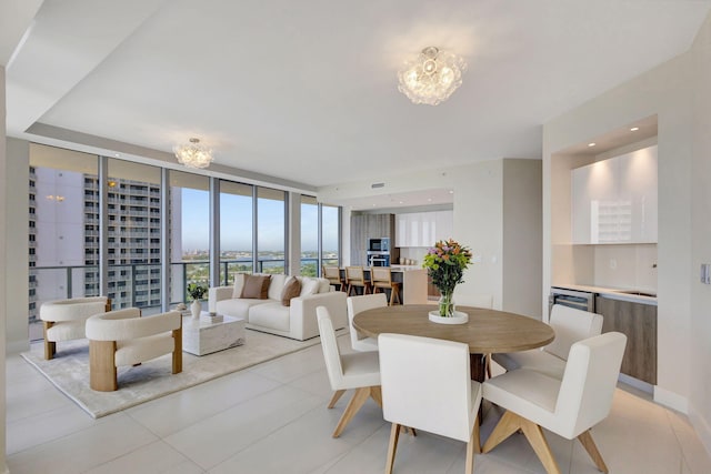 tiled dining area with an inviting chandelier and expansive windows